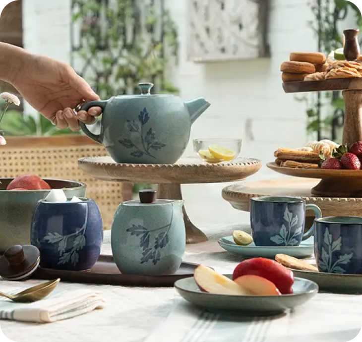 A warm Macha tea set — cups, teapot and snacks